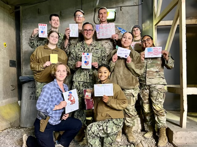 American troops abroad show off the holiday cards they received from PUSD students this month. (Contributed photo)
