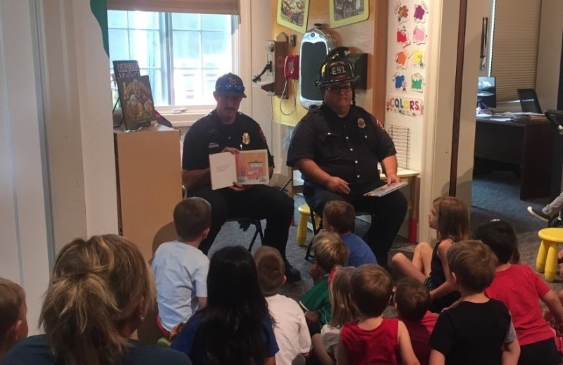 Local firefighters read to preschoolers at a past M.o.M.'s Reading Time. (Photo courtesy Museum on Main)